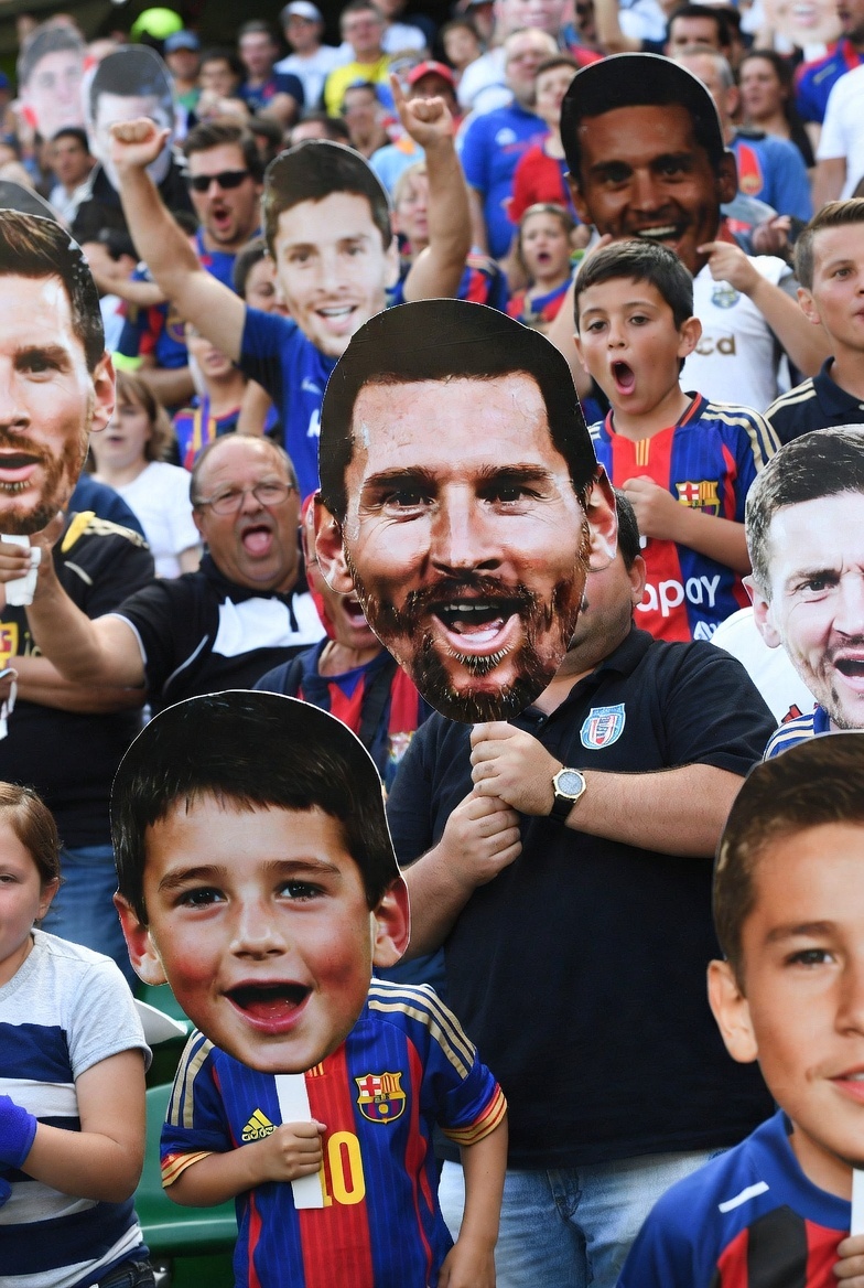 fans with big head cutout of soccer players